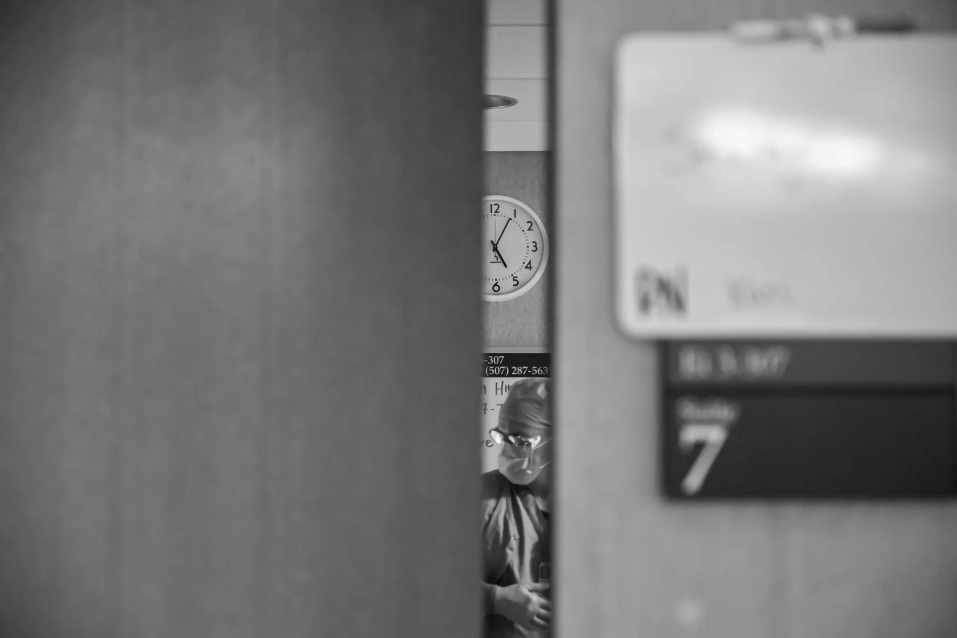 Birth photography — doctor through delivery room door — Amy Minikus Photo + Film