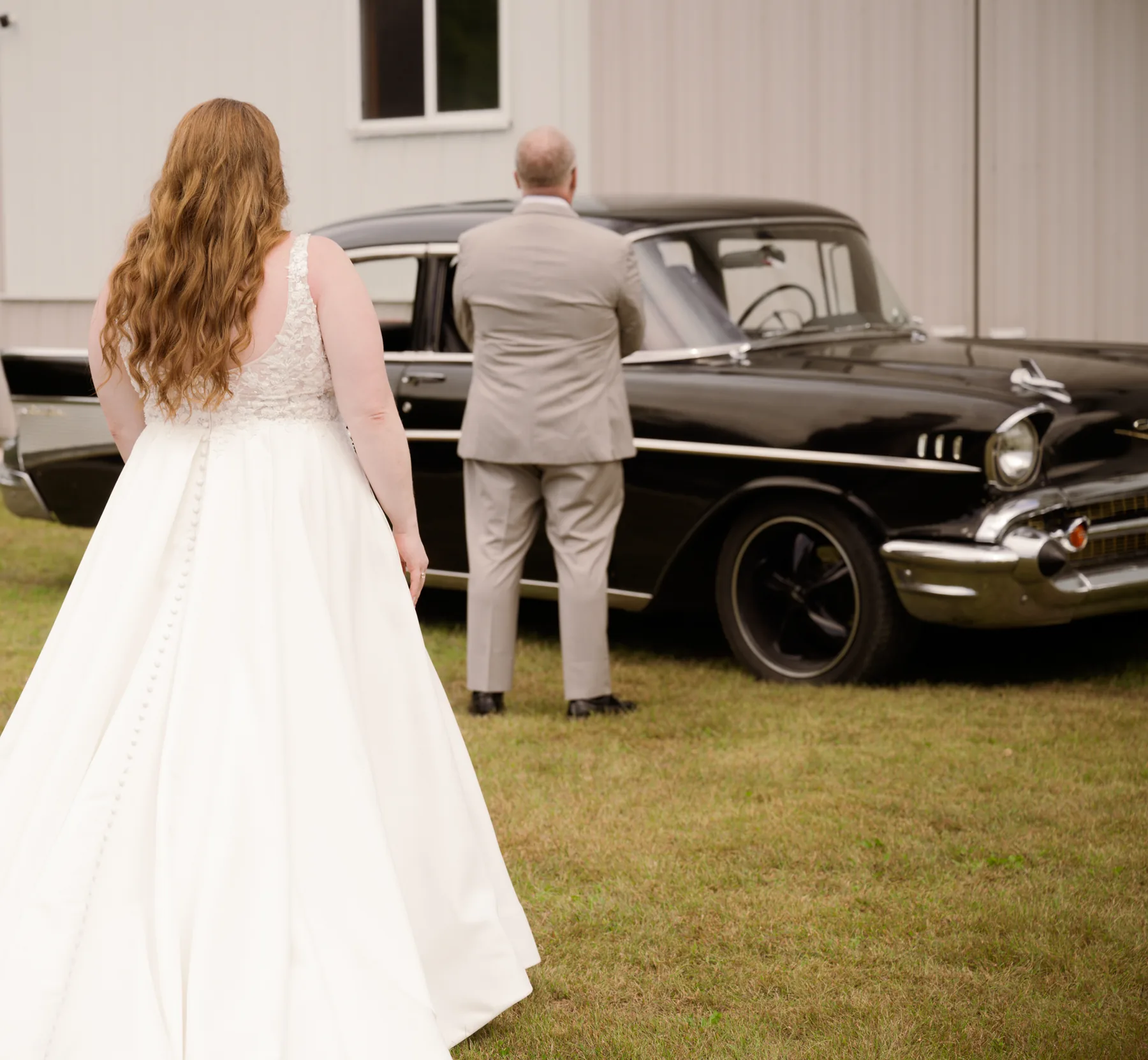 Kelsey crossing the grass toward the black Bel Air in her satin gown, her father holding the door open for her